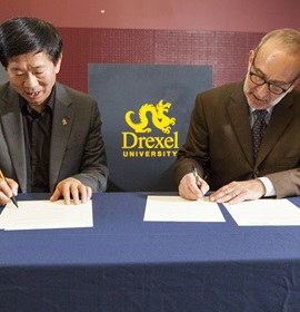 Wang Min, dean of CAFA’s School of Design, and Allen Sabinson, dean of the Westphal College, signed a memorandum of understanding (MOU) at the opening reception on Oct. 4. Photo credit: Shan Cerrone.